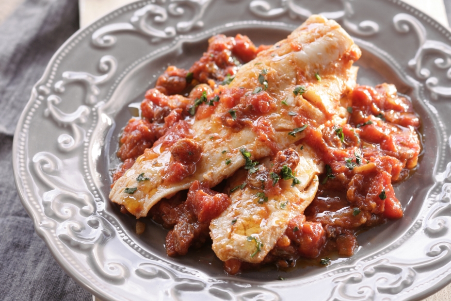 Salt Cod in light tomato sauce with spices and raisins.