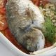 Tsipoura, or gilthead bream, roasted with tomatoes, fennel and ouzo