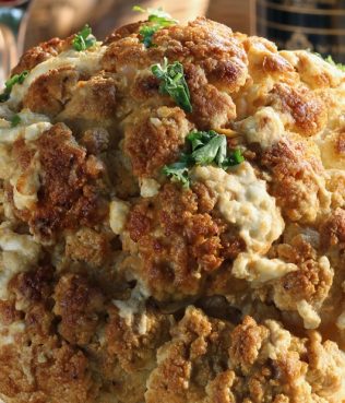 Whole Cauliflower Roasted with Mustard, Honey, Feta, and Garlic