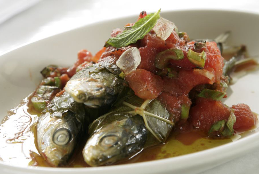 Fresh sardines wrapped in grape leaves and baked