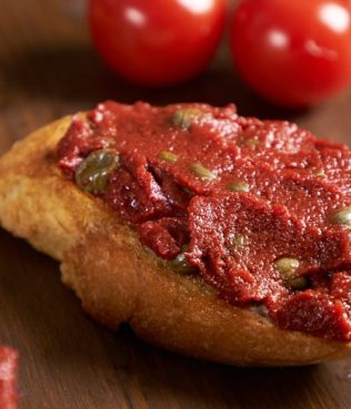 Bertes me Capari (Tomato Paste-Caper Dip) on Bruschetta