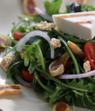 Arugula Salad with Dried Figs, Wrinkled Olives and Pasteli