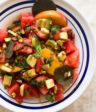 Greek Salad with Heirloom Tomatoes, Santorini Capers, Aegina Pistachios, Watermelon, Peaches & Avocado