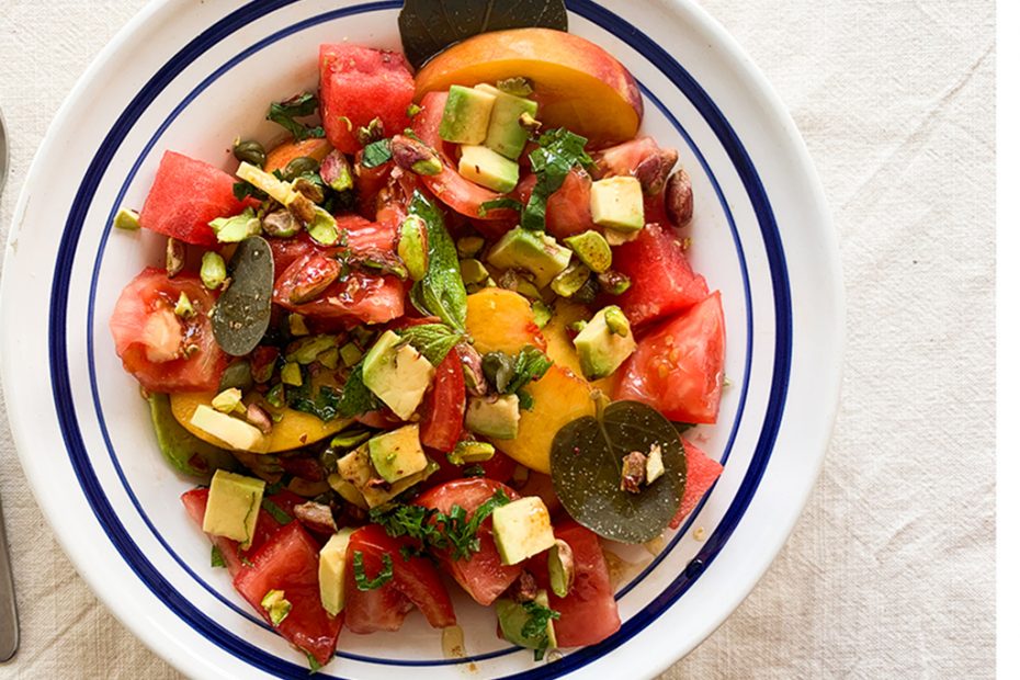 Greek salad with peaches, watermelon, tomatoes, capers and pistachios