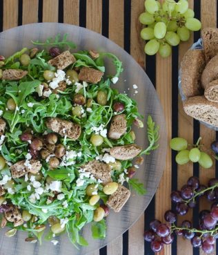 Greek Salad with Rusks, Roasted Grapes, Aegina Pistachios & Arugula