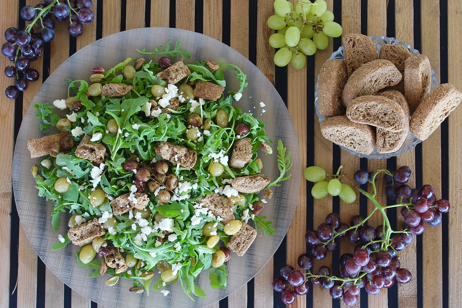 Greek Salad with Rusks, Roasted Grapes, Aegina Pistachios & Arugula