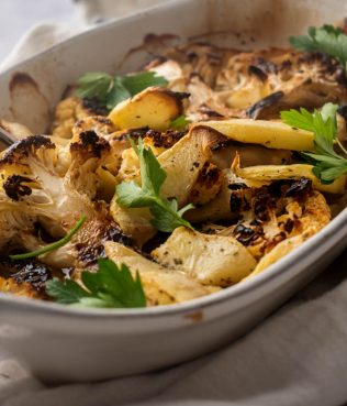 SEARED CAULIFLOWER STEAKS BAKED OVER HERBED APPLES