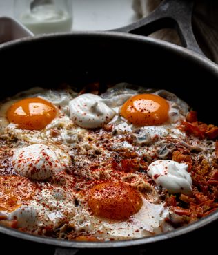 Sunny Side Up Eggs Cooked Over Spicy Vegetables