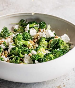 GREEK-STYLE WARM BROCCOLI SALAD WITH LEMON, OLIVE OIL, HERBS AND PINE NUTS