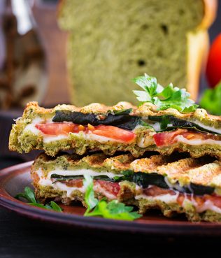 HERBY GRILLED PANINI WITH CARAMELIZED ONIONS, SPINACH, VEGAN OR REAL MOZZARELLA AND TOMATOES