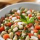 Broad green bean salad with tomatoes, onions and mint