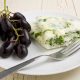 Egg white and spinach omelet with fruit on a white plate