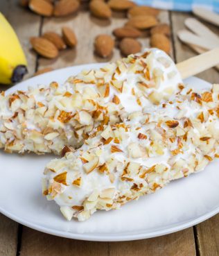 Frozen Banana Covered With Yogurt And Almonds