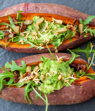 Greek-Inspired Sweet Potatoes Stuffed with Guacamole, Olives and Arugula