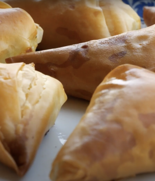 Tyropitakia - phyllo triangles stuffed with feta & herbs Tyropitakia - phyllo triangles stuffed with feta & herbs