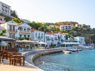 Traditional village of Evdilos, in Ikaria island, Greece Scenic view of Evidlos, a beautiful village and port located in the middle of Ikaria Island, Greece. The photo captures the serene atmosphere, traditional architecture, and the picturesque Aegean Sea, showcasing the timeless beauty of this Greek island village.
