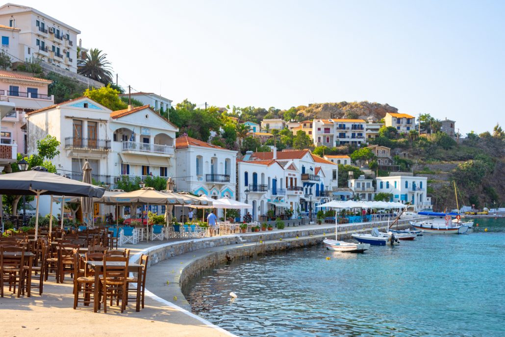 Scenic view of Evidlos, a beautiful village and port located in the middle of Ikaria Island, Greece. The photo captures the serene atmosphere, traditional architecture, and the picturesque Aegean Sea, showcasing the timeless beauty of this Greek island village.